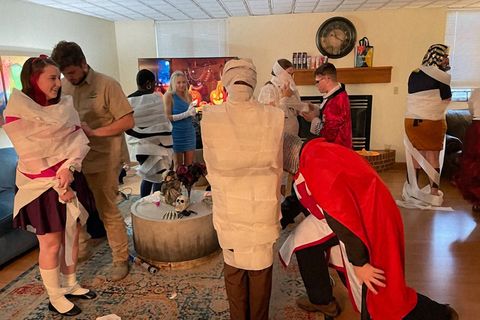 group of students playing mummy game at WVU Collegiate Recovery halloween party