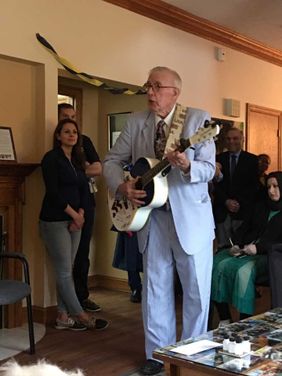 WVU alumni George Daugherty plays guitar at WVU Collegiate Recovery graduation celebration