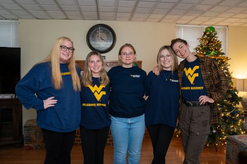 WVU Collegiate Recovery student employees smile for group photo at Serenity Place