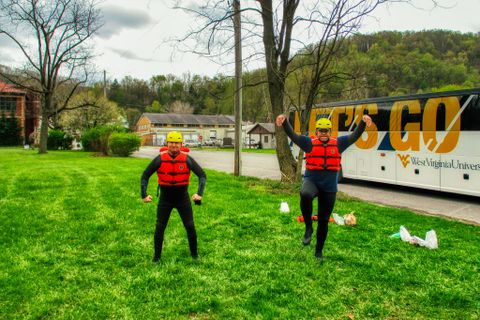 students in rafting gear posing for photo