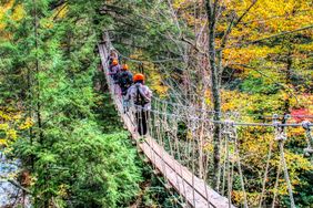 Members of Mountaineers for Recovery crossing a cable bridge at Adventures on the Gorge.
